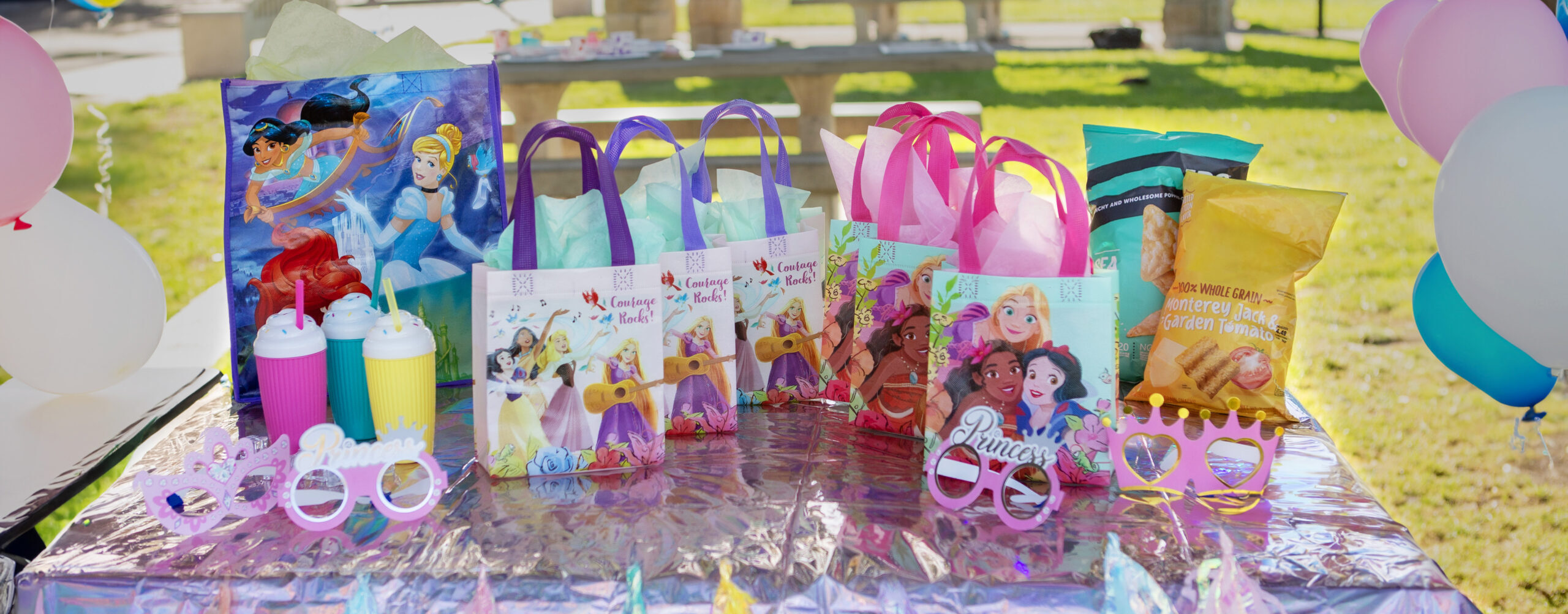 Disney princess mini tote bags on a table for a birthday party